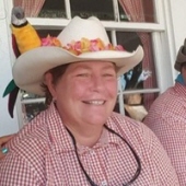 Laura Madara in a white cowboy hat, smiling